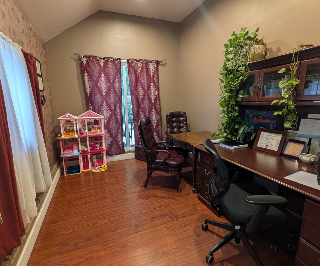 A quiet corner of the office with bookshelves and plants